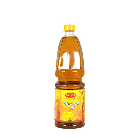 Bottle of Schani Mustard Oil on a gray background